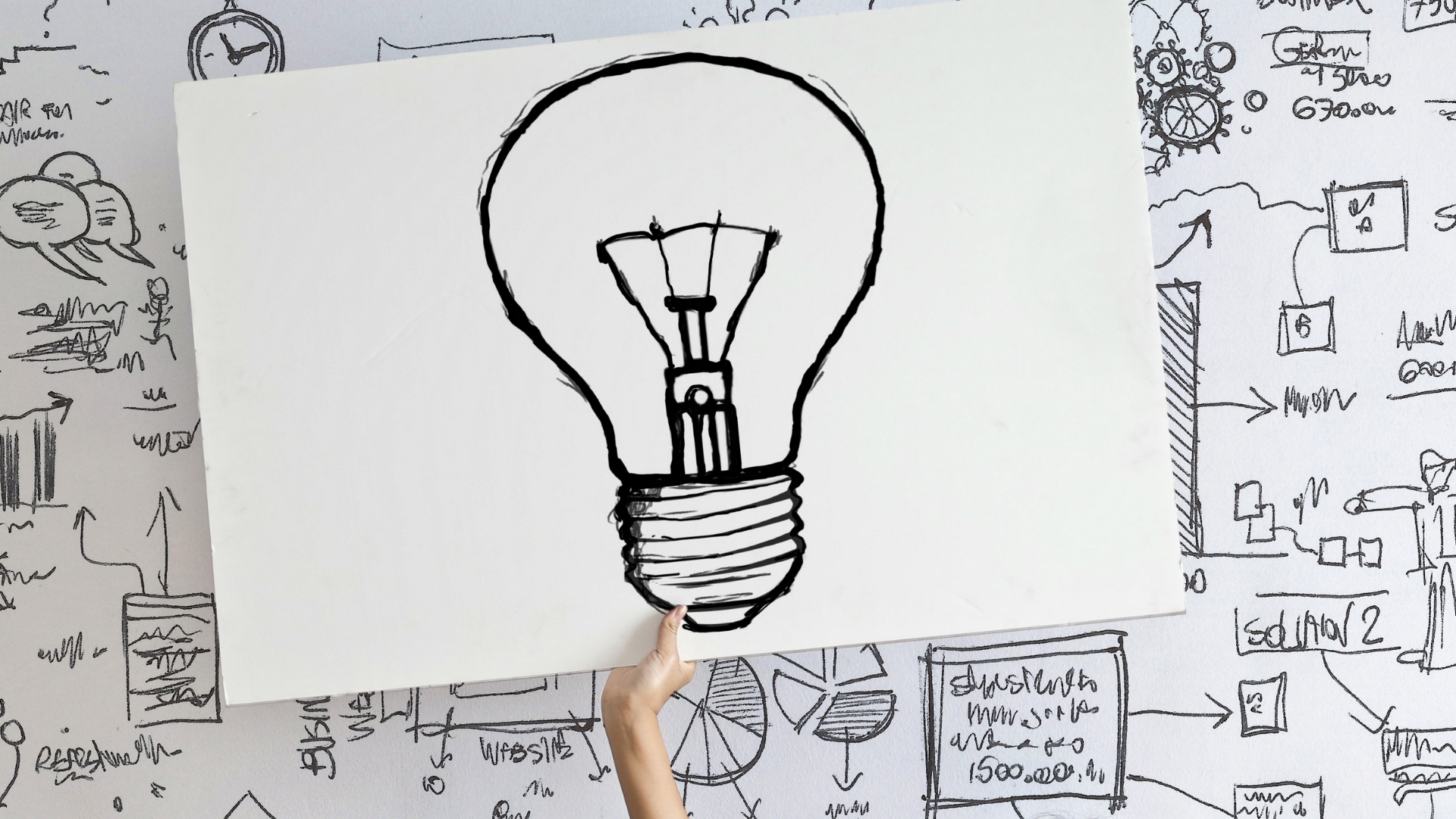 woman-draw-a-light-bulb-in-white-board