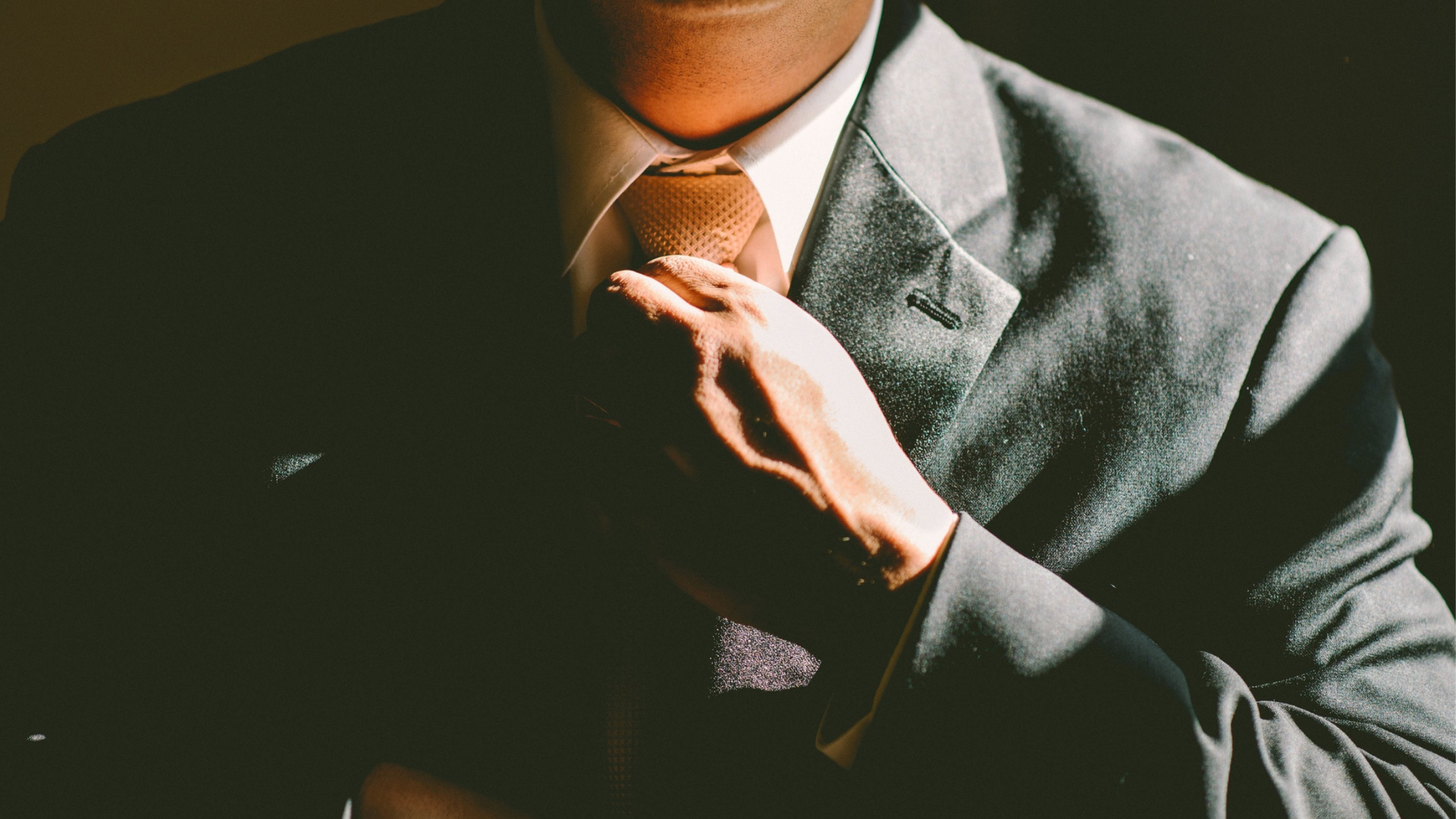 businessman-adjusting-his-necktie